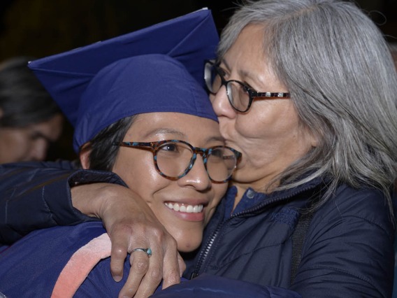 Breanna Lameman gets a congratulatory kiss from her mother, JoAnn Lameman, after receiving her Master of Public Health diploma at the Mel and Enid Zuckerman College of Public Health fall convocation.