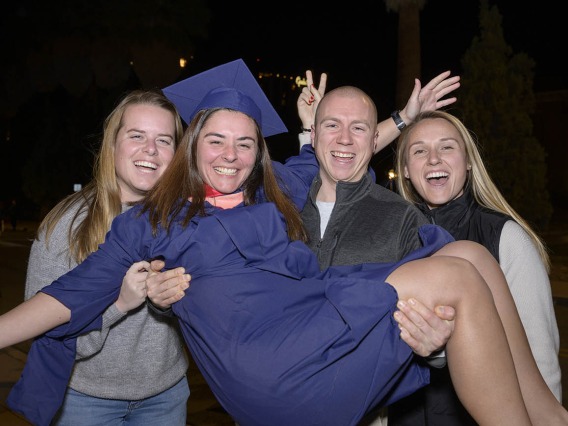 Casey McCormick celebrates earning her Master of Public health degree with friends (from left) Emma Strand, Nick Palumbo and Ingrid Freeman after the Mel and Enid Zuckerman College of Public Health fall convocation.