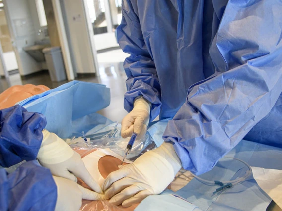 ASTEC’s SimDeck is a two-story soundstage and training environment with multiple reconfigurable rooms where health care providers, such as these critical care residents, can practice medical procedures in simulated environments.