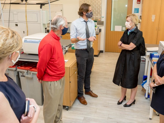 Deborah Birx, MD, coordinator of the White House Coronavirus Task Force, visited University of Arizona and UArizona Health Sciences laboratories where researchers are testing antibody and antigen samples collected from students and employees. Ryan Sprissler, PhD, staff scientist and manager of the UArizona Genetics Core, speaks with Dr. Birx as UArizona President Robert C. Robbins, MD, and others, listen.