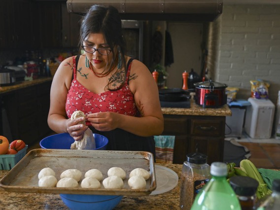 Diné College student Alyssa Joe prepares fry bread for a dinner with colleagues from the Center for Innovation in Brain Science, where she took part in a 10-week neurosciences program. 
