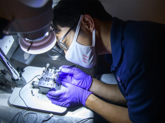 Dongkyun Kang, PhD, has created a portable prototype of a microscope used to help diagnose skin cancer. Here, he works to improve the device assembly.