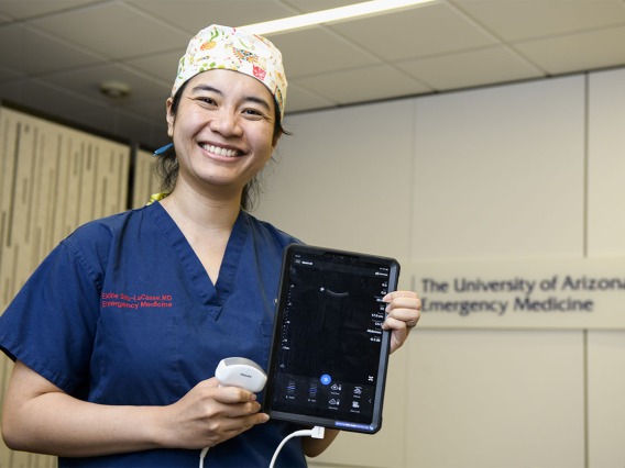Holding a bedside ultrasound device, Elaine Situ-LaCasse, MD, a UArizona College of Medicine – Tucson assistant professor, won a grant to train rural providers on lung ultrasound as a quicker, more efficient way to evaluate patients who may have COVID-19.