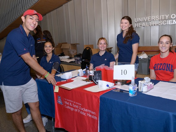 Students volunteer at the Mel and Enid Zuckerman College of Public Health information table during the inaugural Feast for Your Brain community event on Sept. 10. 