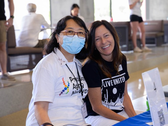 (From left) Zhao Chen, PhD, MPH, professor and associate dean for research in the Mel and Enid Zuckerman College of Public Health, and Elizabeth Cozzi, associate vice president of community development at the United Way of Tucson, pause for a moment at the Feast for Your Brain event.