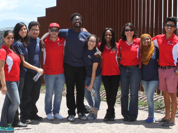 FRONTERA interns learn firsthand about the challenges affecting the U.S.-Mexico border region. Here, the 2014 cohort is pictured on a fieldtrip to the border wall. Ray Larez, MPH, is third from the left, and Alejandra Zapien Hidalgo, MD, MPH, is third from the right.