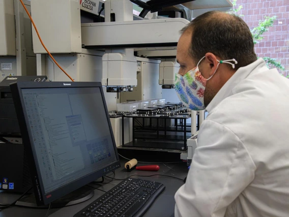 Matthew Kaplan, manager of University of Arizona Functional Genomics Core, makes some adjustments during the evaluation of the Biomek robot prior to testing blood samples for antibodies to the virus that causes COVID-19. 