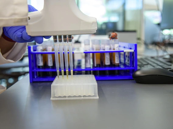 Barbara Fransway, manager of University of Arizona Genetics Core Research Services, transfers blood serum into testing plates.