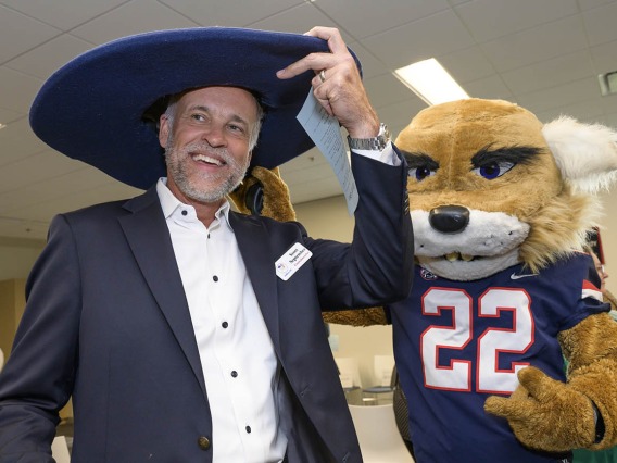 Gilbert, Arizona, town council member Scott September tries on Wilbur Wildcat’s hat during the ribbon-cutting event at the UArizona College of Nursing’s renovated facility. 