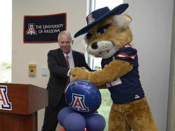 Wilbur Wildcat jokes around with University of Arizona President Robert C. Robbins, MD, at the UArizona College of Nursing’s ribbon-cutting ceremony in Gilbert, Arizona.