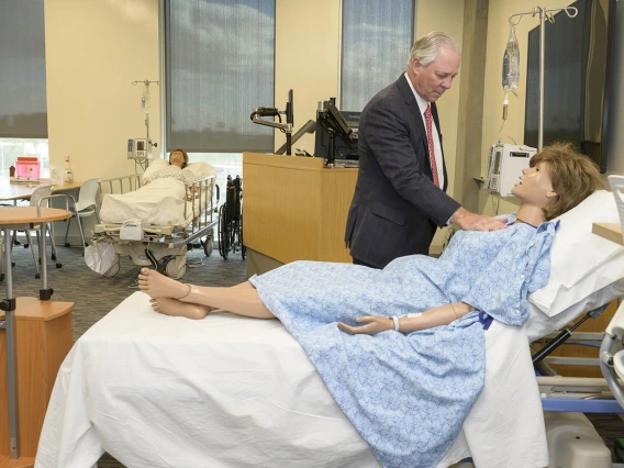 University of Arizona President Robert C. Robbins, MD, an internationally recognized cardiac surgeon, checks the simulated heart rate of a manikin in the College of Nursing’s renovated third-floor simulation lab in Gilbert, Arizona.