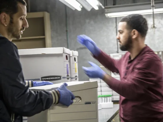 Biorepository laboratory technicians Brandon Jernigan and Ayman Sami, load boxes of COVID-19 sample collection kits to deliver to Banner-University Medical Center Tucson.