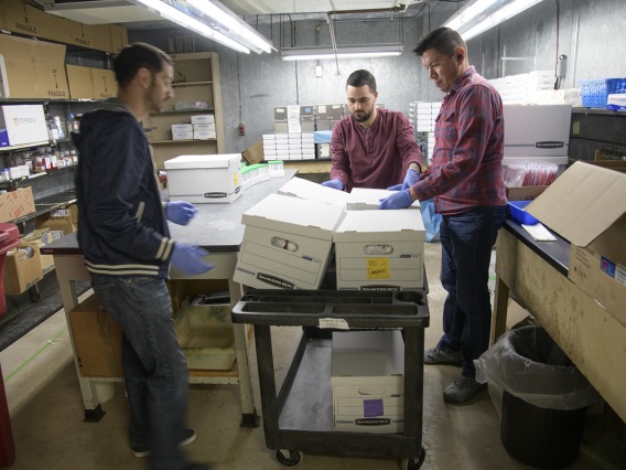 Biorepository laboratory technicians Brandon Jernigan, Ayman Sami, and Jose Camarena, load boxes of COVID-19 sample collection kits to deliver to Banner-University Medical Center Tucson.