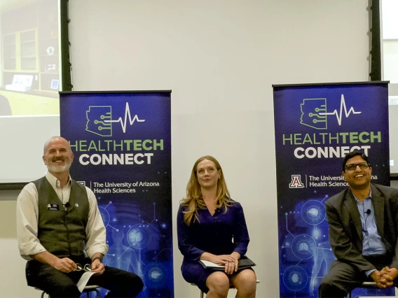 Doug Hockstad (left) of TechLaunch Arizona, facilitated a panel discussion on working with hospital systems and insurers. The panel included Kiran Avancha, PhD, RPh, (right) HonorHealth Research and Innovation Institute, Rachel Mertensmeyer, Rivia Health, and on screen,  Ryan Harper, Tenet Healthcare.