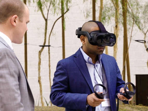 Attendees of the inaugural HealthTech Connect event try out the new virtual reality trainer created by 8chili Inc. 