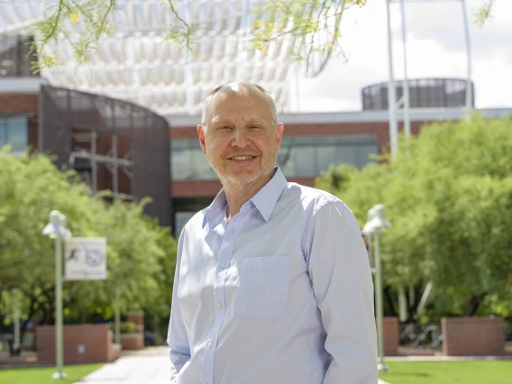 Middle-aged man wearing a light blue shirt while standing outside