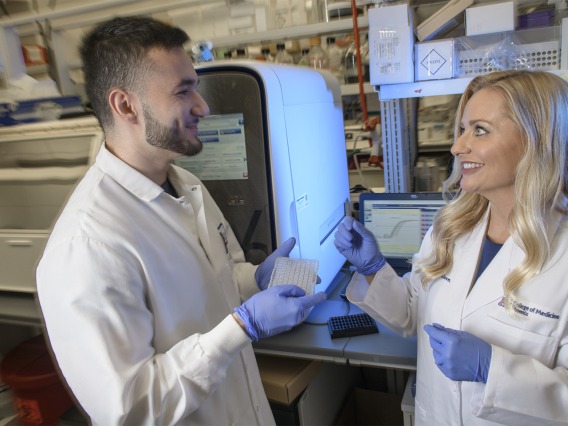Melissa Herbst-Kralovetz, PhD, discusses research findings with Michael Khnanisho, a member of her research team at the University of Arizona College of Medicine – Phoenix and premed student at Arizona State University.