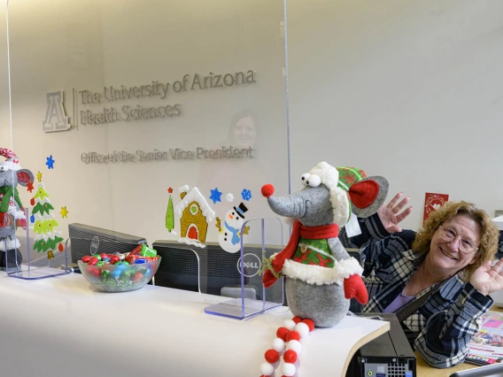 Deb Evano, senior office specialist, greets visitors to the Office of the Senior Vice President for the University of Arizona Health Sciences with holiday cheer and chocolate. 