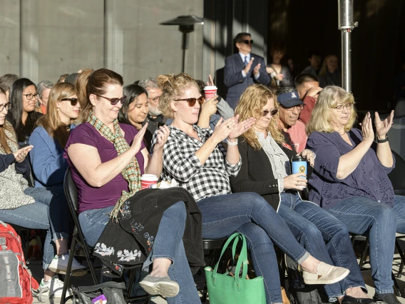 The audience applauds during the blessing ceremony.