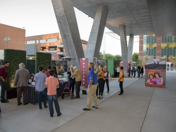 The porch space outside the first floor features tall, covered walkways and seating areas.