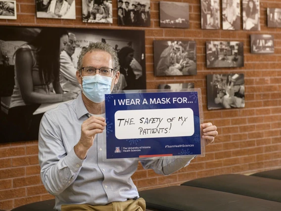 Conrad Clemens, MD, MPH, senior associate dean for graduate medical education at the College of Medicine – Tucson, is modeling safe practices for patients and family.