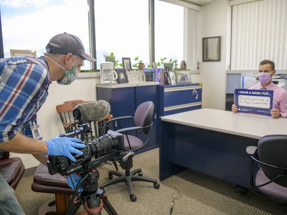 Roy Wageman, videographer in the Health Sciences Office of Communications, records Todd Vanderah, PhD, as he talks about the importance of wearing a mask. Vanderah is director of the Health Sciences Comprehensive Pain and Addiction Center.