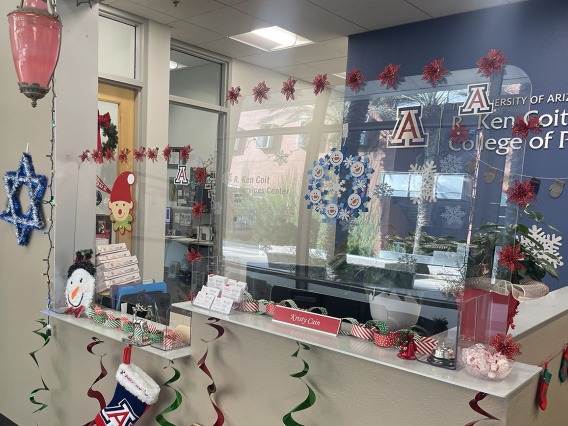 The R. Ken Coit College of Pharmacy Office of Student Services reception area is filled with holiday decorations. 