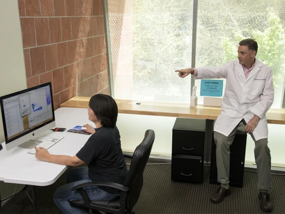 Makiko Watanabe, DVM, PhD, (left), and Janko Nikolich-Žugich, MD, PhD (right), review the results of a preliminary assay that sheds light on the immune response to the virus that causes COVID-19. Their work in the spring led to the community antibody testing the University of Arizona has been conducting since April.