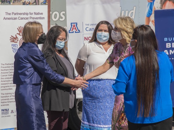 Joann Sweasy, PhD, (left) director of the UArizona Cancer Center, greets first lady Jill Biden, EdD, during her visit to the San Xavier Health Center in the San Xavier District of the Tohono O'odham Nation on March 8, 2022. 