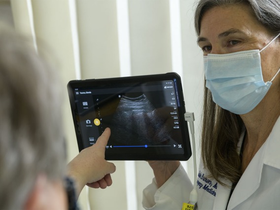 Julia Brown, MD, explains the images from the lung ultrasound to her standardized patient.