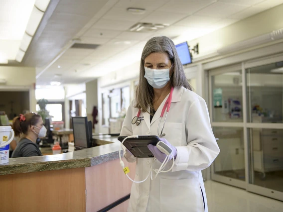 Viewing the results of a lung ultrasound, Julia Brown, MD, leaves the emergency department of the hospital. Evidence is mounting for the effectiveness of lung ultrasound in diagnosing and assessing the severity of coronavirus infections in emergency departments, where it could be an alternative to chest X-ray and CT chest scans when combined with a clinical examination.