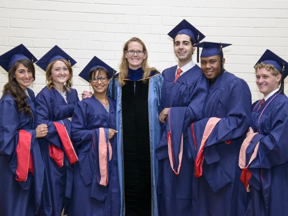 Kacey Ernst, PhD, MPH, poses with students at the 2014 convocation. 