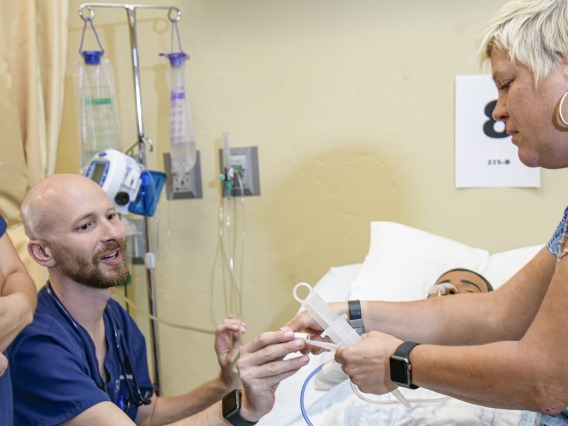 A recent physiology graduate, Nick Knapton (center) studies nursing at the University of Arizona.