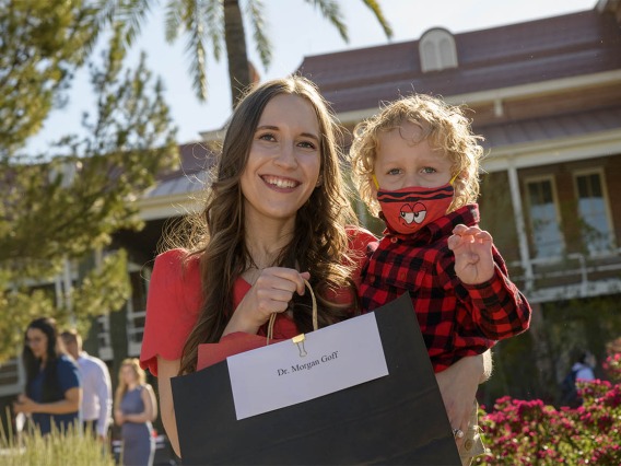 Morgan Goff holds her son Hans Ashby before she can open the envelope that will tell Goff where she has been matched during the UArizona College of Medicine – Tucson 2022 Match Day event.