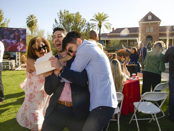 Aaron Masjedi is sandwich-hugged by his mother, Shiva Mahboob, and younger brother Eli Masjedi, after finding out he was matched with the University of Southern California during the UArizona College of Medicine – Tucson 2022 Match Day event on the lawn west of Old Main.