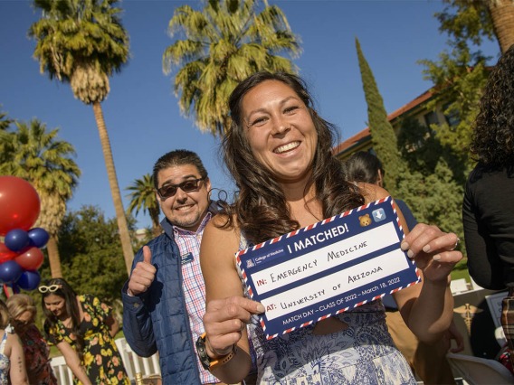 Brianna Dolana holds up her match sign showing that she matched in emergency medicine at the University of Arizona – Tucson during the UArizona College of Medicine – Tucson 2022 Match Day event. 