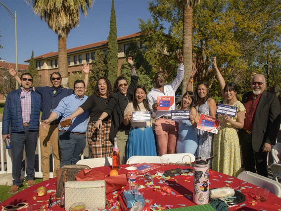 Several third-year medical students along with faculty and staff celebrate with fourth-year students who received their residency matches (holding signs) during the UArizona College of Medicine – Tucson 2022 Match Day event. (From left) Patrick Bryan, Justin Kaye, Ray Larez, Kaloni Philipp, Dinorah Jaime, Naiby Rodriguez, Caylan Moore, Paulina Ramos, Brianna Dolana, Carmen Zaldivar, Carlos Gonzales, MD. 