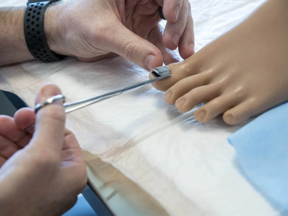 The College of Nursing uses lifelike manikins to practice removing toenails.