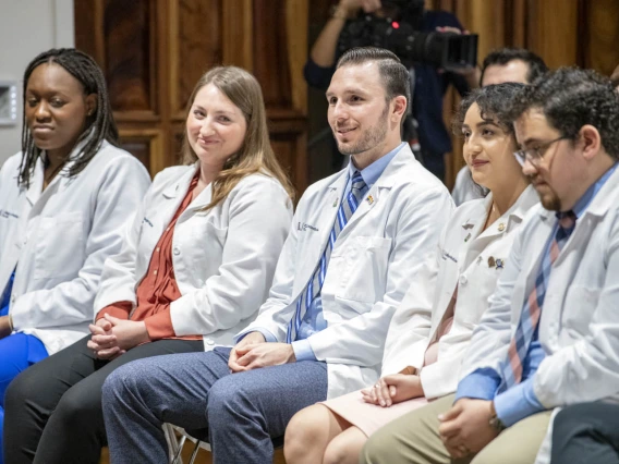 Primary Care Physician scholarship recipients listen to Dr. Carlos Gonzales speak during the reception. 