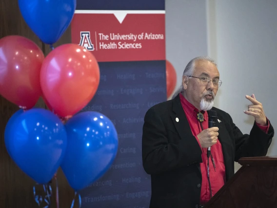 Dr. Carlos Gonzales speaks to attendees during the Tucson Primary Care Physician scholarship reception. 