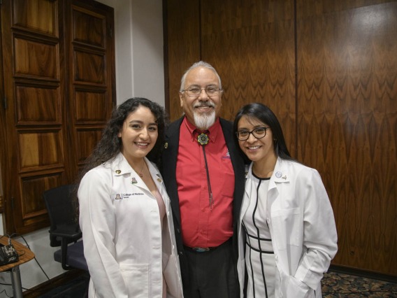 Primary Care Physician scholarship recipients Guadalupe Davila and Cazandra Zaragoza pose for a photo with Dr. Carlos Gonzales at the Tucson scholarship reception. 