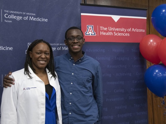Primary Care Physican scholarship recipient Oumou Bah poses for a photo with her family. 
