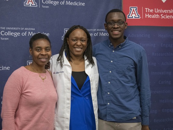 Primary Care Physican scholarship recipient Oumou Bah poses for a photo with her family. 