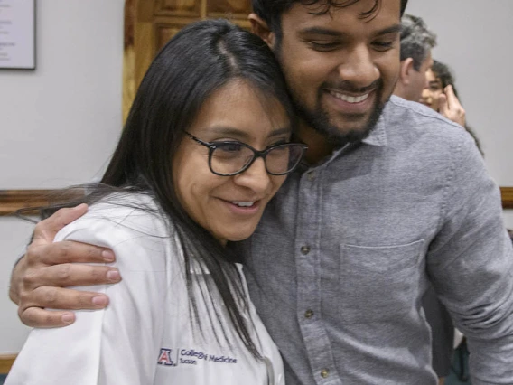 A friend hugs Cazandra Zaragoza after the Tucson Primary Care Physician scholarship reception. 