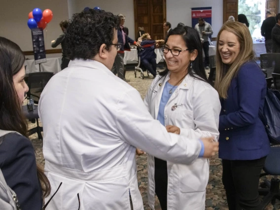 Primary Care Physician scholarship recipient Raymond Larez, MPH, congratulates Naiby Rodriguez at the Tucson scholarship reception. 