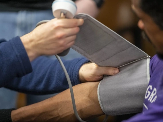 Street Medicine Phoenix co-founder Justin Zeien checks a patient’s blood pressure.