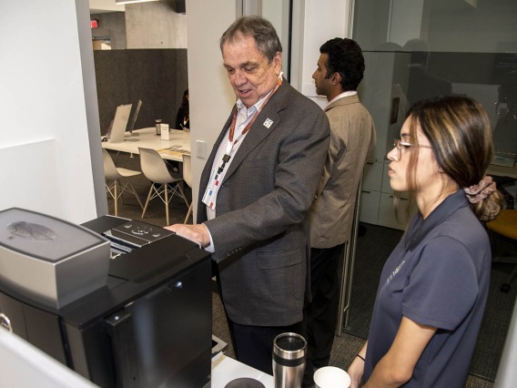 University of Arizona Senior Vice President of Health Sciences Michael D. Dake, MD, uses the new espresso machine inside the Faculty Commons + Advisory