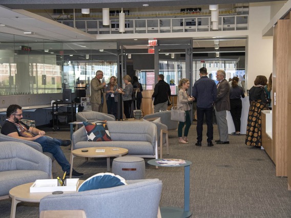 Attendees check out the new space during the grand opening of the Faculty Commons + Advisory event. 