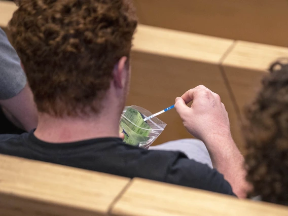 A student examines a Rapid Response testing kit, used to determine if drugs are laced with fentanyl, during the Drug Survival 102 panel presentation.