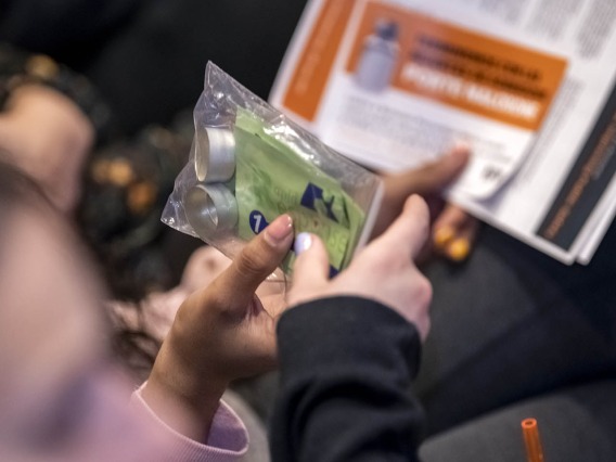 Attendees pass around a Rapid Response testing kit during the Drug Survival 102 panel presentation.